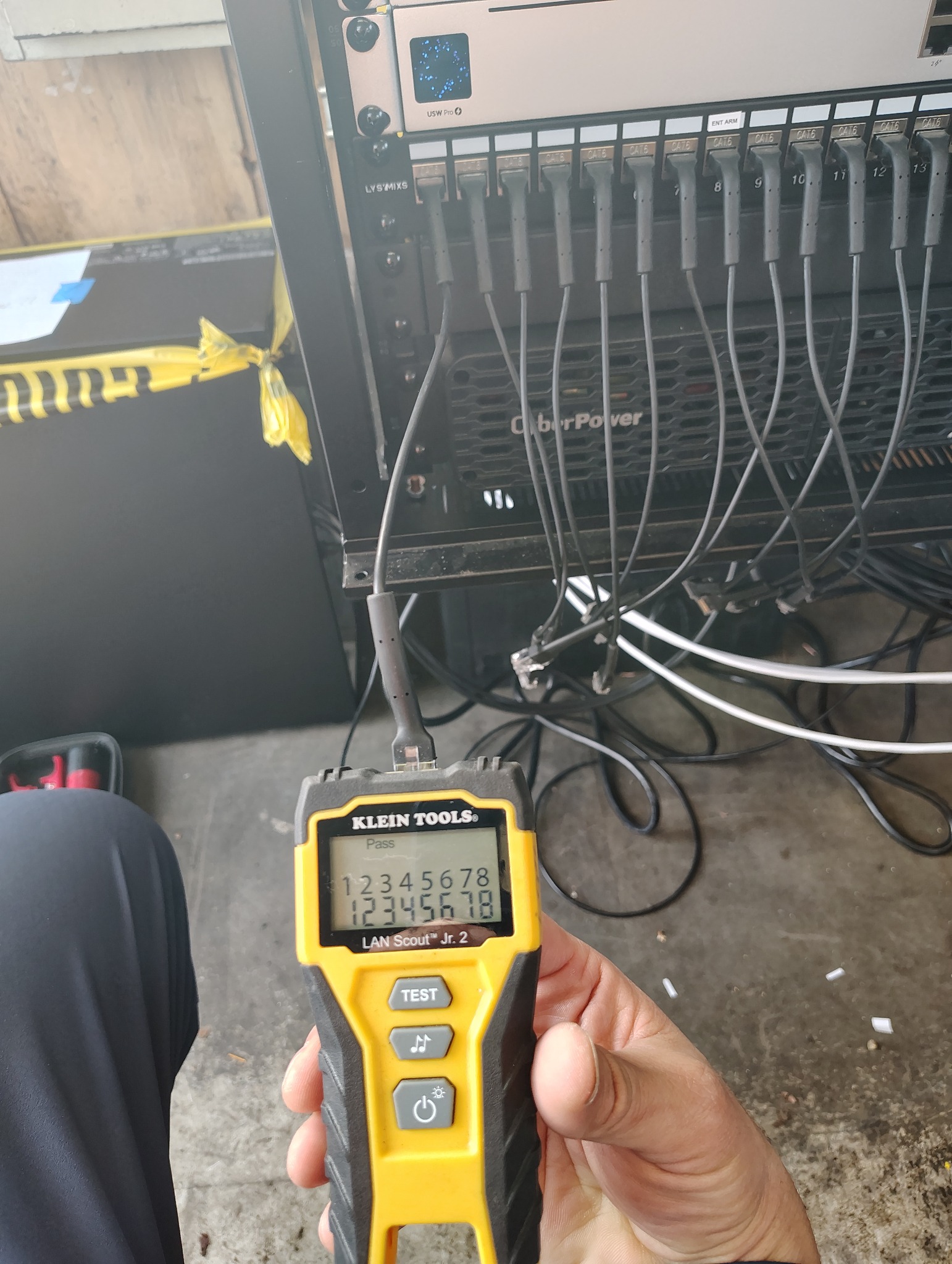 Technician testing and documenting commercial network cabling