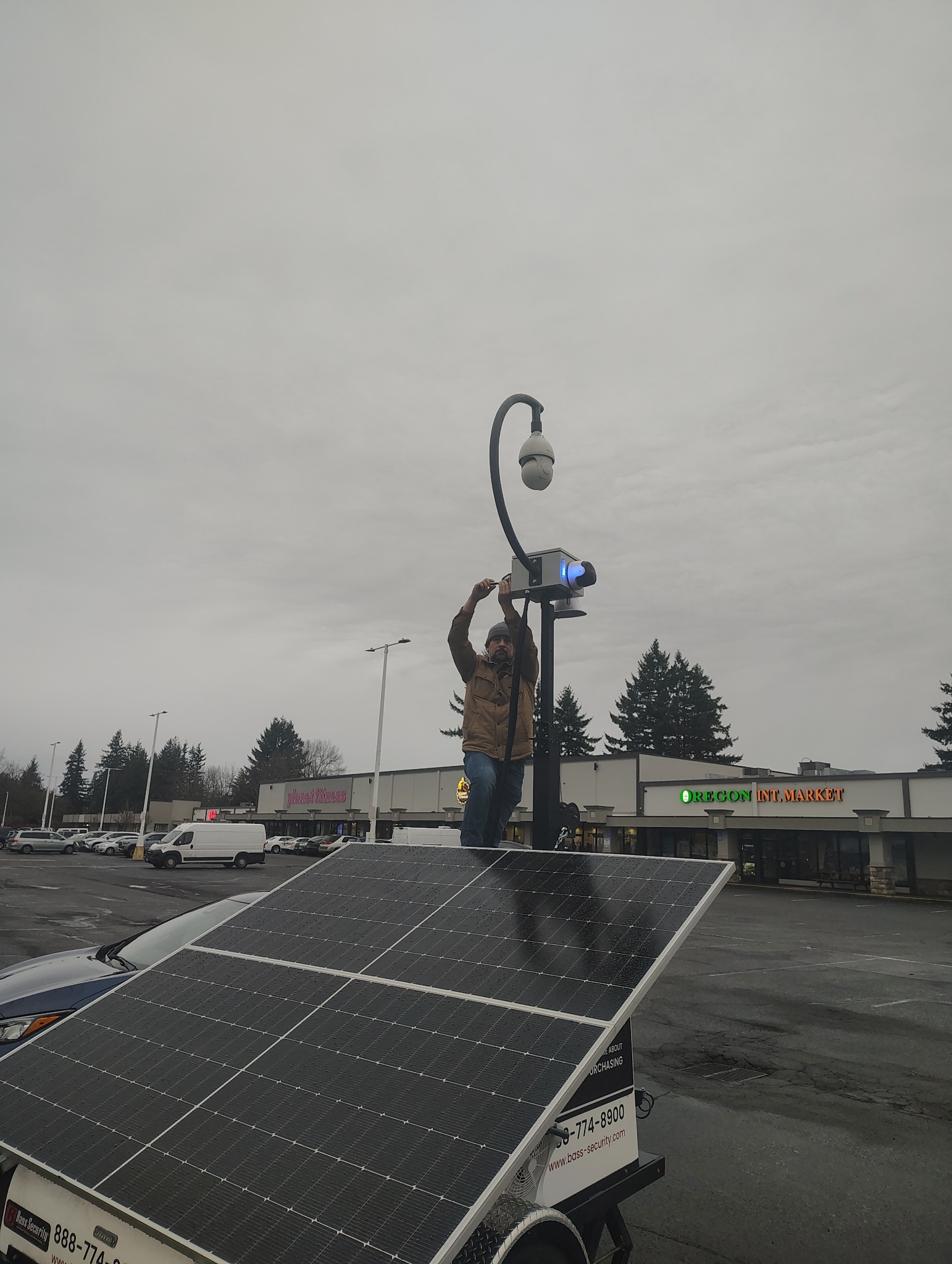 Commercial surveillance camera installation performed from a ladder